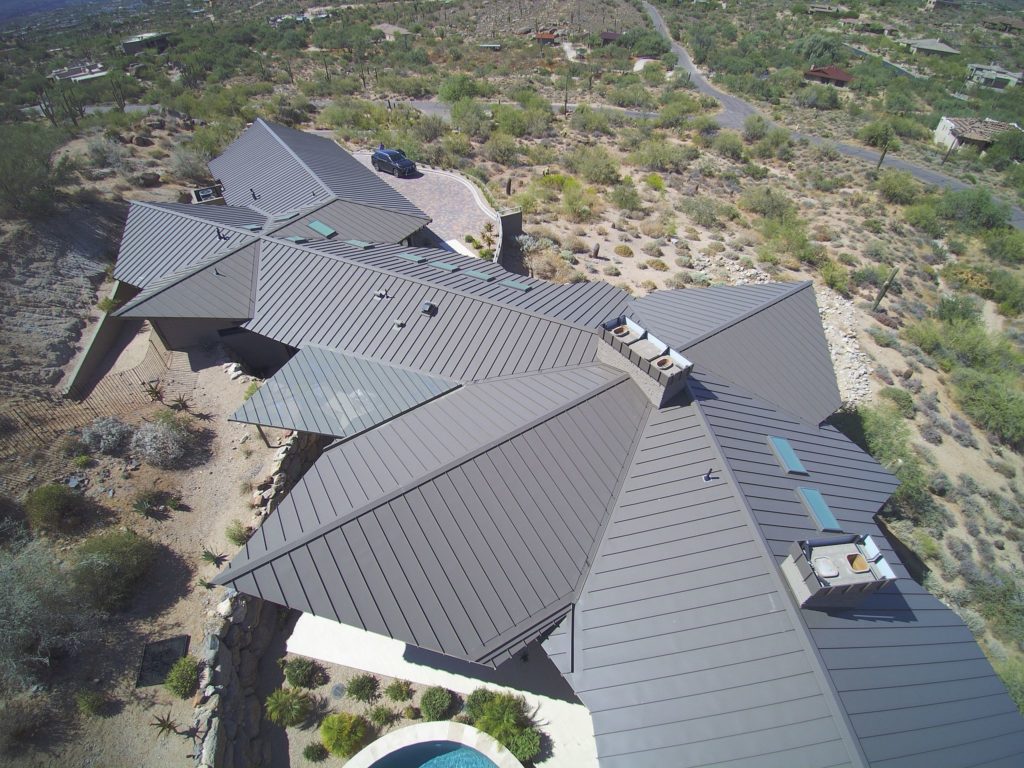 A complex standing seam metal roof on a home in Arizona.