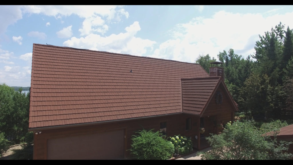 A brown stone coated steel roof that looks like shakes.