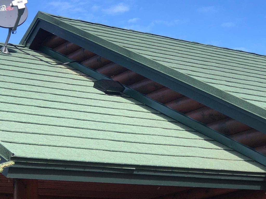 A close-up of a green stone coated steel roof.