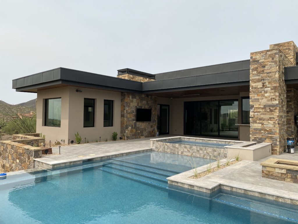 An Arizona home with a swimming pool and new facia board installed by Vertex Roofing.