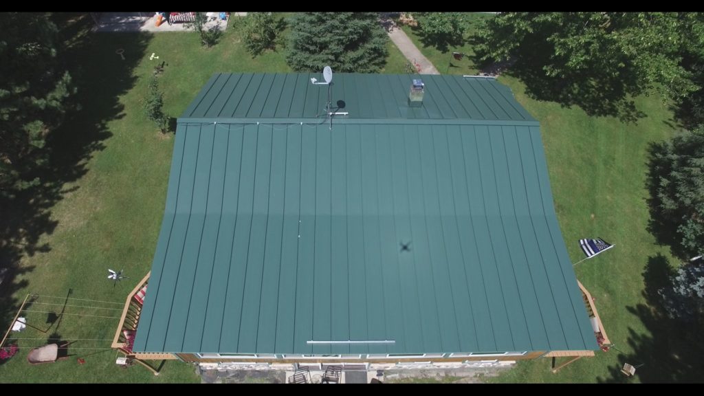 A dark green metal roof on a house.