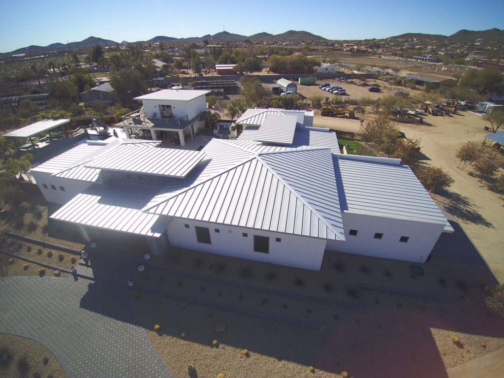 A white house with a light gray metal roof