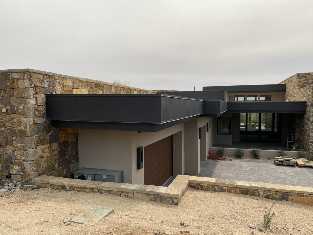 A home with new brown soffit fascia installed by Vertex Metal Roofing