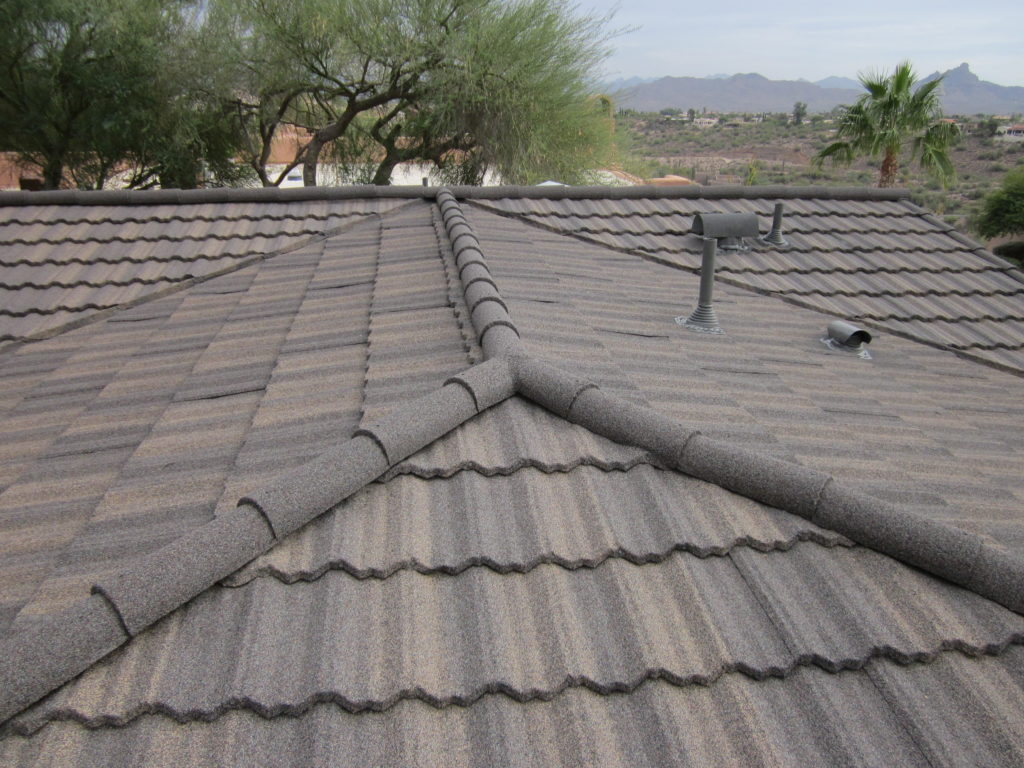 A closeup image of a brown stone coated steel roof.
