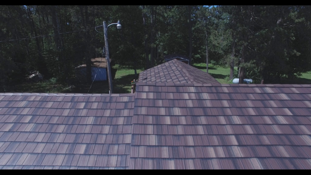 Closeup image of a new metal shake roof installation.