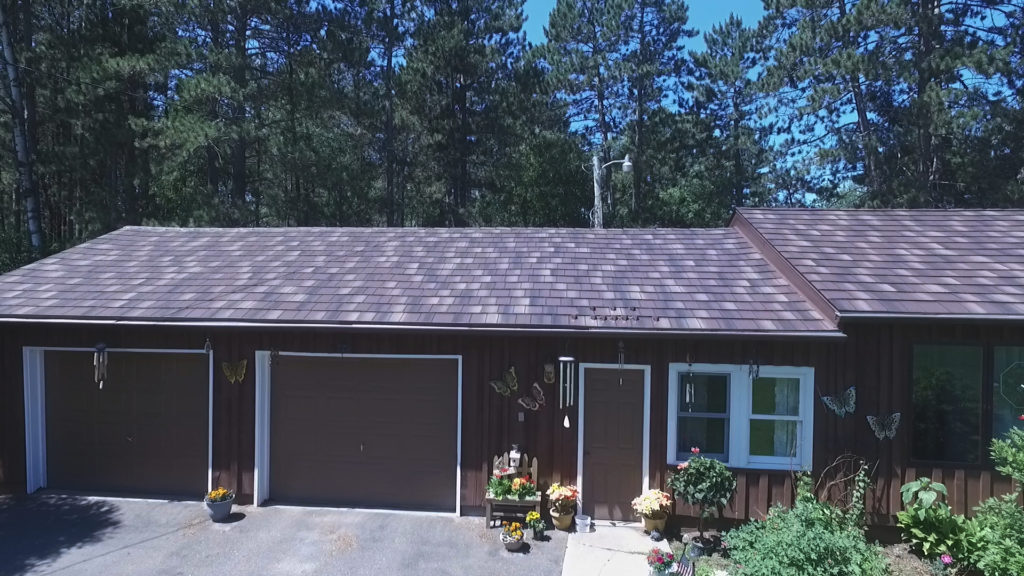 Front view of a home with a new metal shake roof.