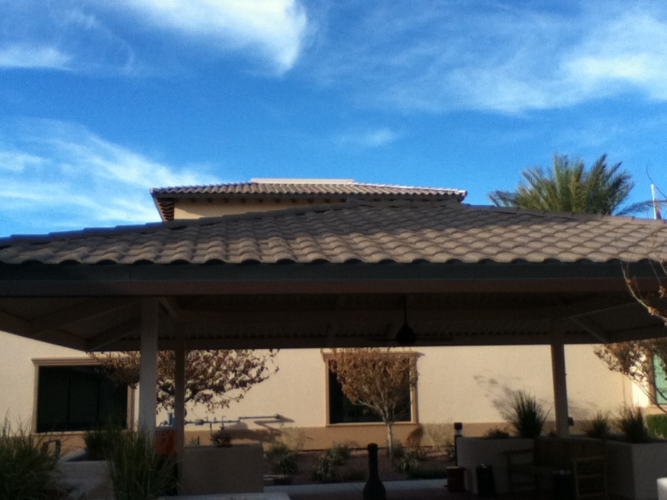 Side view of a home with a brown stone coated steel roof.