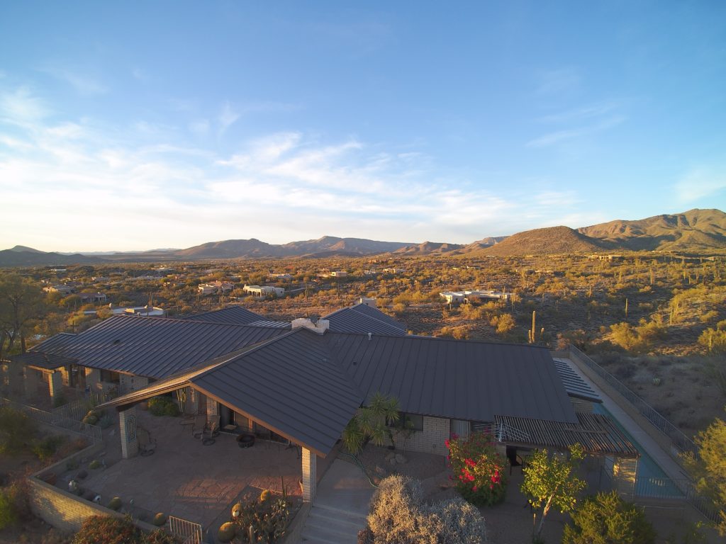 A metal roof covering a home and outdoor living space in Arizona.