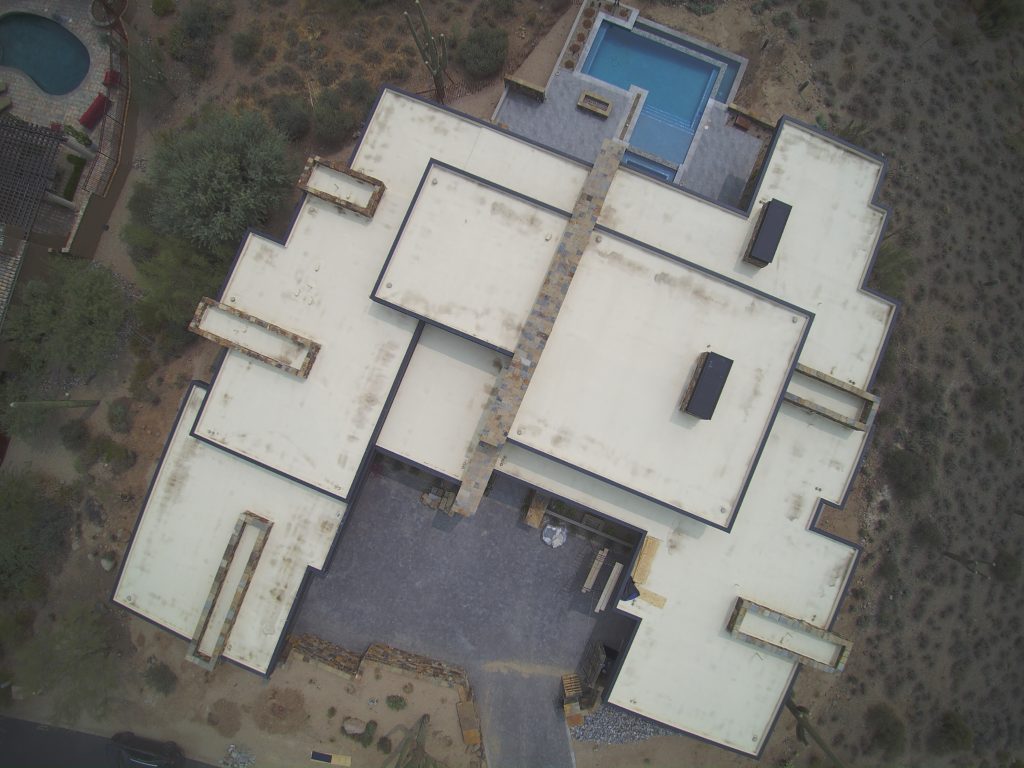 A drone view of a large Arizona home with new soffit fascia and wall panels completed by Vertex Metal Roofing