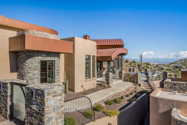 modern style home in Phoenix with a curved metal roof.