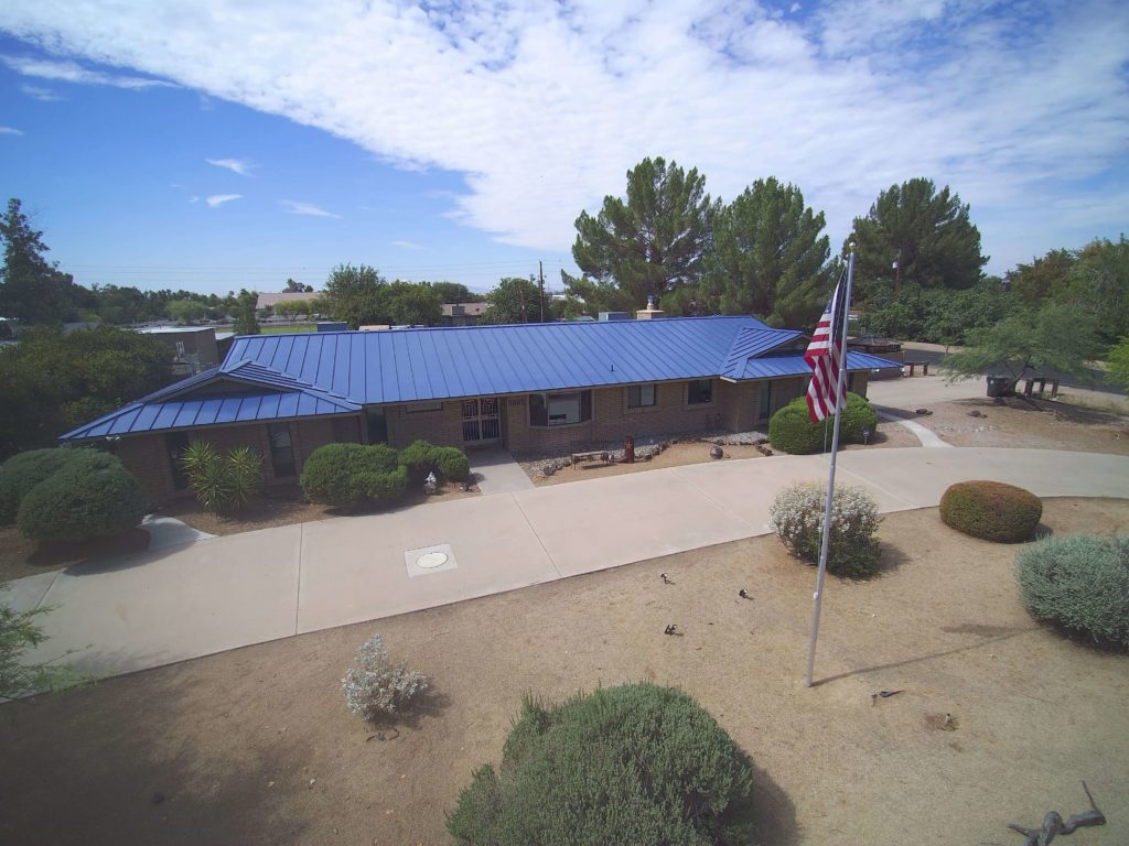 A home in Arizona with a blue standing seam metal roof.